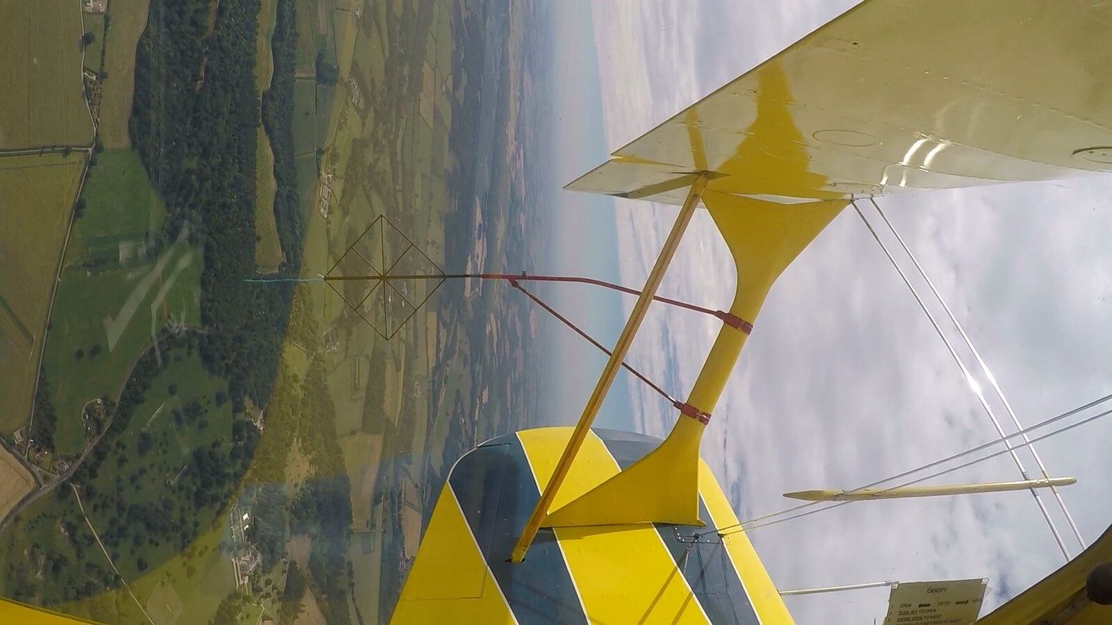 Stunt flight aircraft in the sky during an aerobatic experience from White Waltham